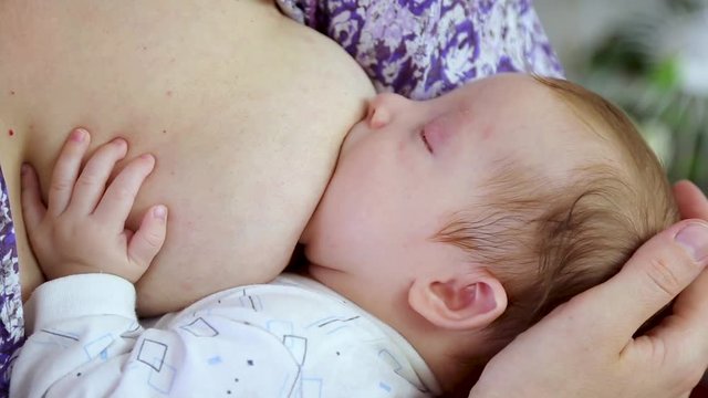 breastfeeding a newborn baby, closeup