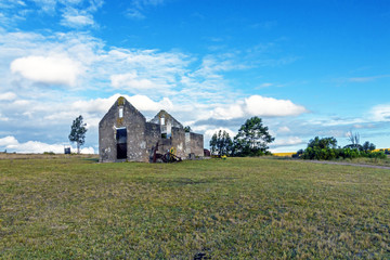 Fototapeta na wymiar Rural Old Derelect Farm Building on Dry Winter Landscape