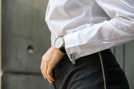 Image of woman hand at business suit wearing white shirt with cufflinks and watch resting her hand