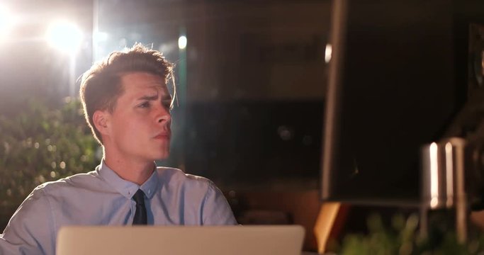 Financial manager working alone in empty dark office
