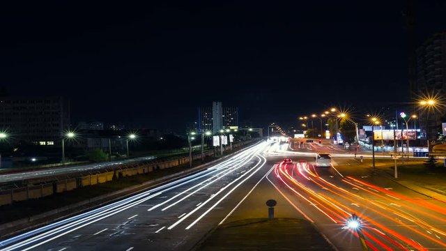 Car light trails and city traffic at night. Time lapse.
