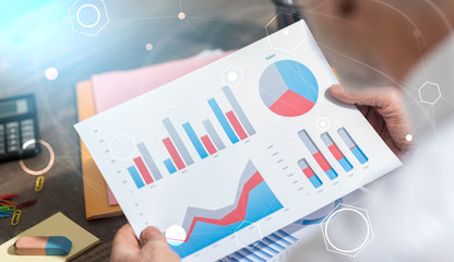 Businessman analyzing financial data, double exposure, light effect