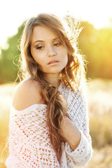 Beautiful lady model in an open field at sunrise