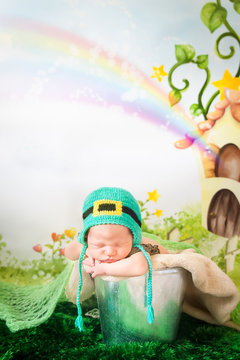 Sleeping newborn baby in a St. Patrick's Day hat