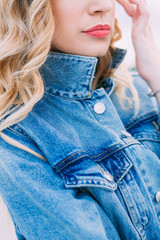 Close-up of a girl's face, dressed in a denim jacket,
