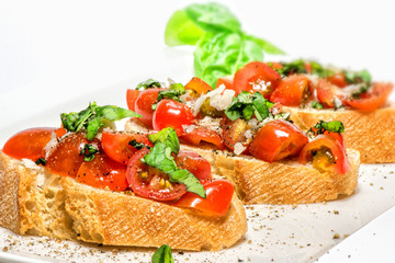 Fototapeta na wymiar Fresh tomato basil bruschetta on toast
