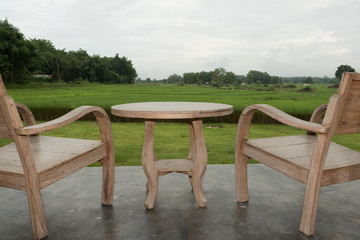 Chair for outdoor with rice field background and cloudy sky.