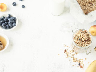 Granola in a jar with fruits and milk.