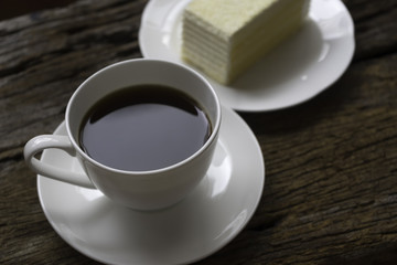 A cup of coffee and a piece of cake
