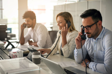 People in operations center  talking on Landline phone. Operators in the office.