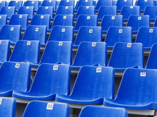 Naklejka premium Dark blue rows of seats on the stadium
