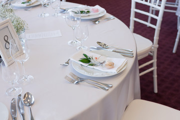 table setting with spoon, knife, plates and glass