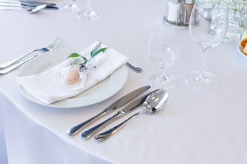 table setting with spoon, knife, plates and glass
