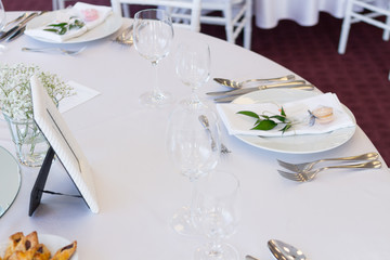 table setting with spoon, knife, plates and glass