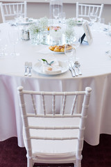 table setting with spoon, knife, plates and glass