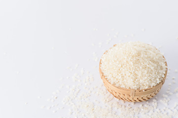 Fototapeta na wymiar raw rice in a bamboo basket isolated on white background 