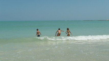 children playing in the sea