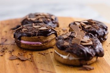 Cinnamon cookies and marshmallow sandwich topped by chocolate and chocolate flakes