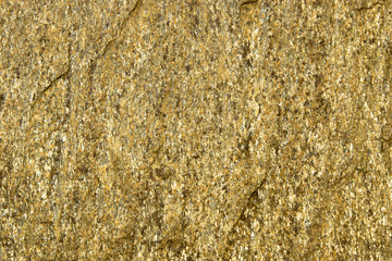 Background of stone with gold flecks. Stone rock with gold particles.