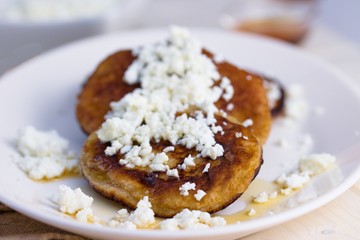 Homemade gluten free pancakes with cottage cheese and honey served on oval plate