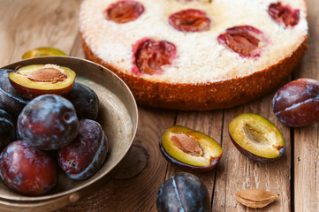 Pie with plum. In rustic style on a wooden surface