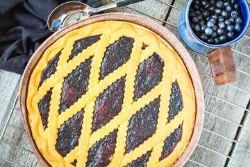 Home open blueberry cake on a wooden background