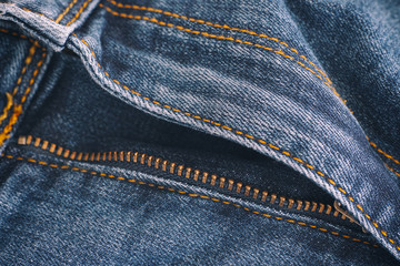 Closeup of blue jeans with open zipper