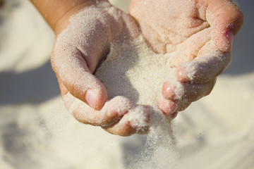 sand in both hands at the beach