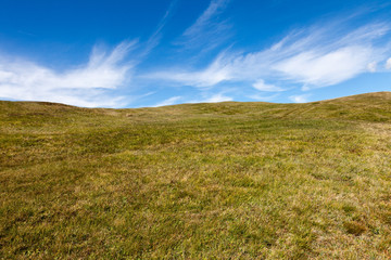 Fototapeta premium Mountain pasture on the background of blue sky