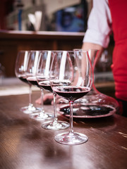 Sommelier filling glass with red wine in restaurant