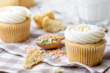 Tasty cupcakes on a white wooden table