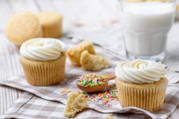 Tasty cupcakes on a white wooden table