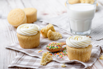 Tasty cupcakes on a white wooden table