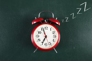 Back to school background with alarm clock 
