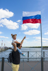 Russian Federation flag. Little girl & her father showing Russian flag with their hands