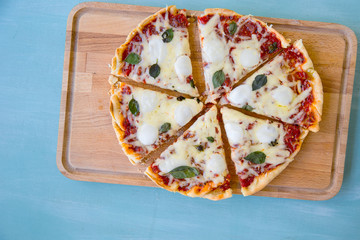 pizza with bacon, mozzarella on a blue background