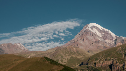 Mount Kazbek view from Stepantsminda town in Georgia in good weather for climbing. It is a dormant stratovolcano and one of the major mountains of the Caucasus.