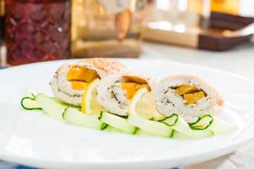traditional Polish dishes. Selective focus on appetizing delicious meat snacks with lemon and cucumber on a white plate