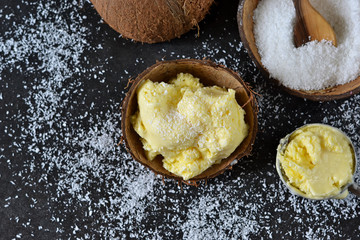 Vanilla ice cream with coconut on a concrete black background. Summer dessert.