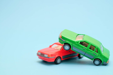 Toy cars in accident on a blue background