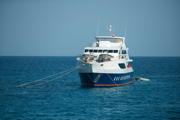 Fototapeta na wymiar Ship sailing on background of sea water and blue sky
