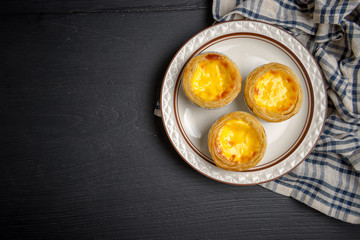 egg tart on black wood