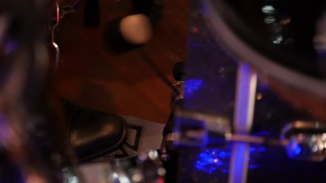 kick pedal bass drum, reflection of the hands musician playing the drum set. jazz drummer performing on stage Slow motion close-up