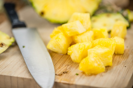 Wooden table with Sliced Pineapple, selective focus