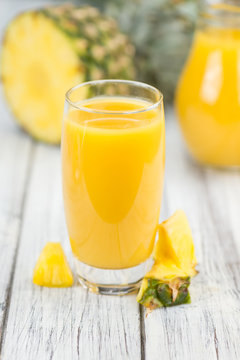 Fresh made Pineapple Juice on a rustic background