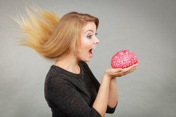 Crazy woman holding brain wanting to eat it