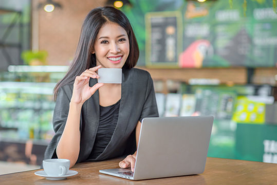 Asian woman holding credit card
