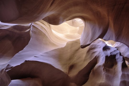 Sun ray through Antelope colorful canyon wall erosion in desert