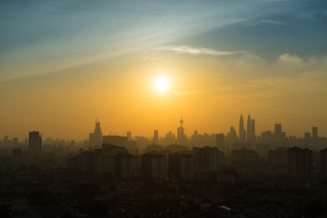 Majestic sunset over Petronas Twin Towers and surrounded buildings in downtown Kuala Lumpur, Malaysia 