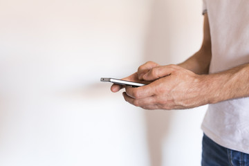 man hands holding a smartphone over white background. Lifestyle